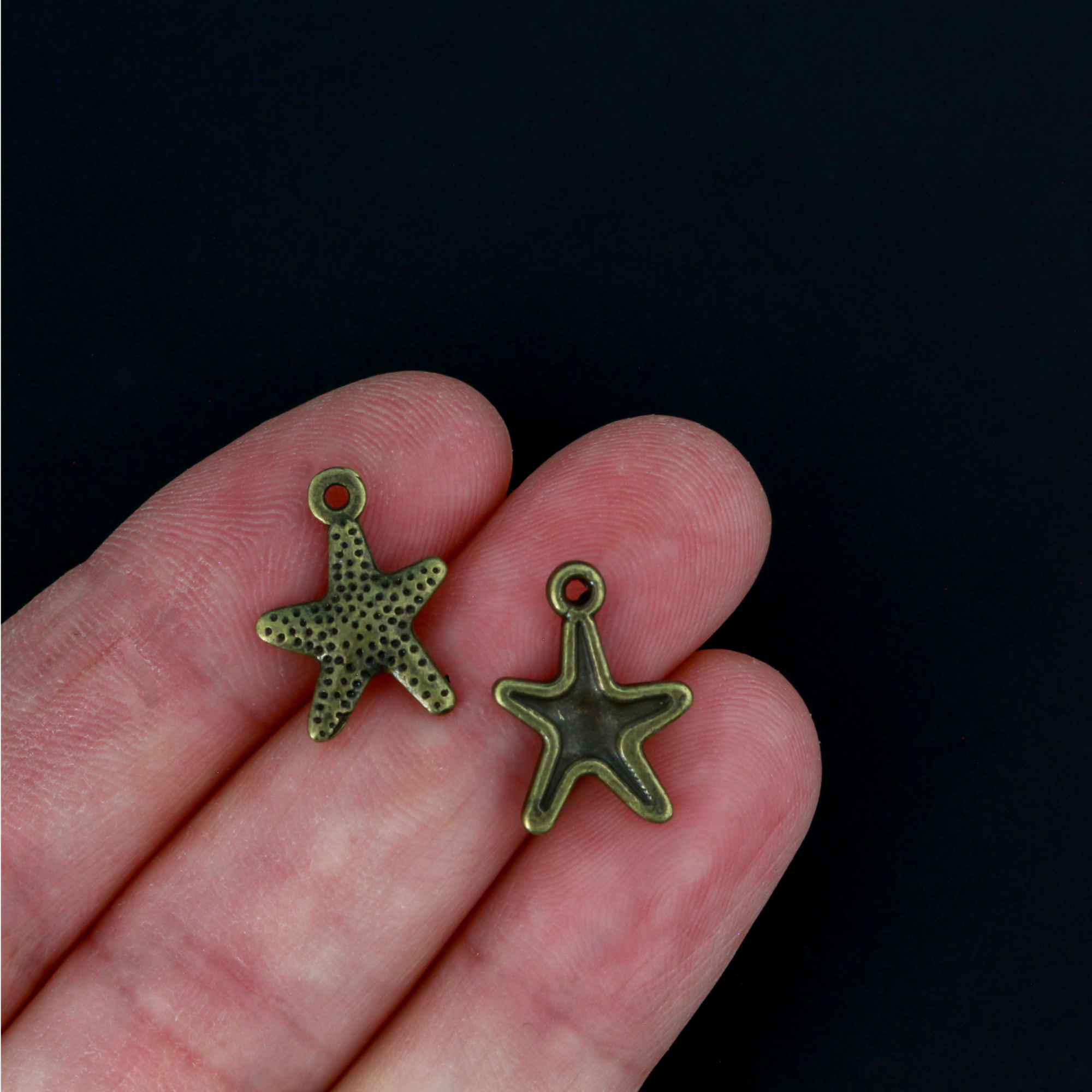 16mm long starfish charms in an antiqued bronze color.
