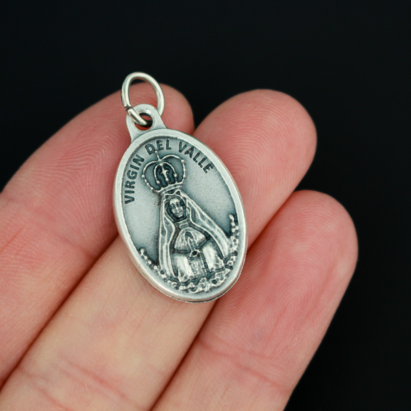 Virgin of the Valley medal that depicts Mary on the front and "Pray for us" on the back