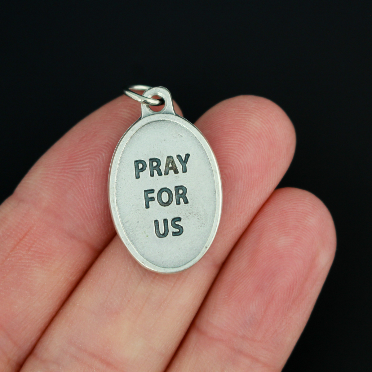 Virgin of the Valley medal that depicts Mary on the front and "Pray for us" on the back