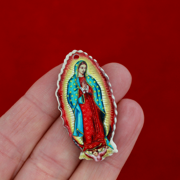 crylic pendants with a printed full color image of Our Lady of Guadalupe. The image is reversed on the backside