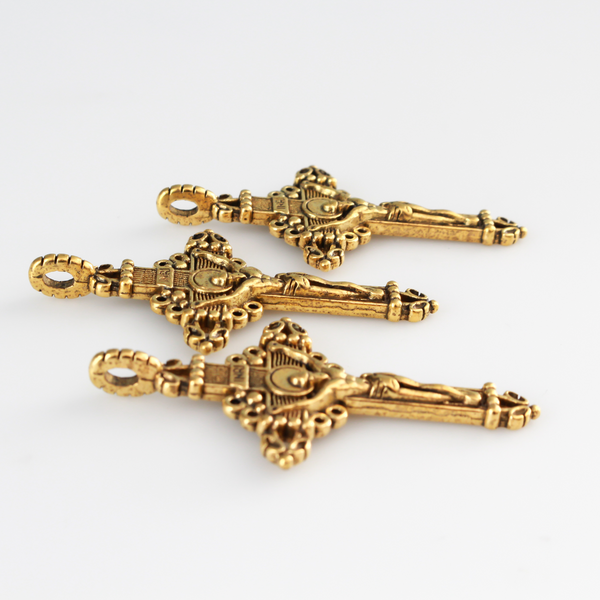 Three ornate crucifix crosses in an antiqued gold-tone color. This is a larger size crucifix measuring 2" long