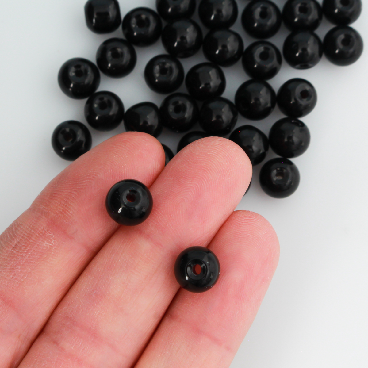 8mm round beads in a solid black color.