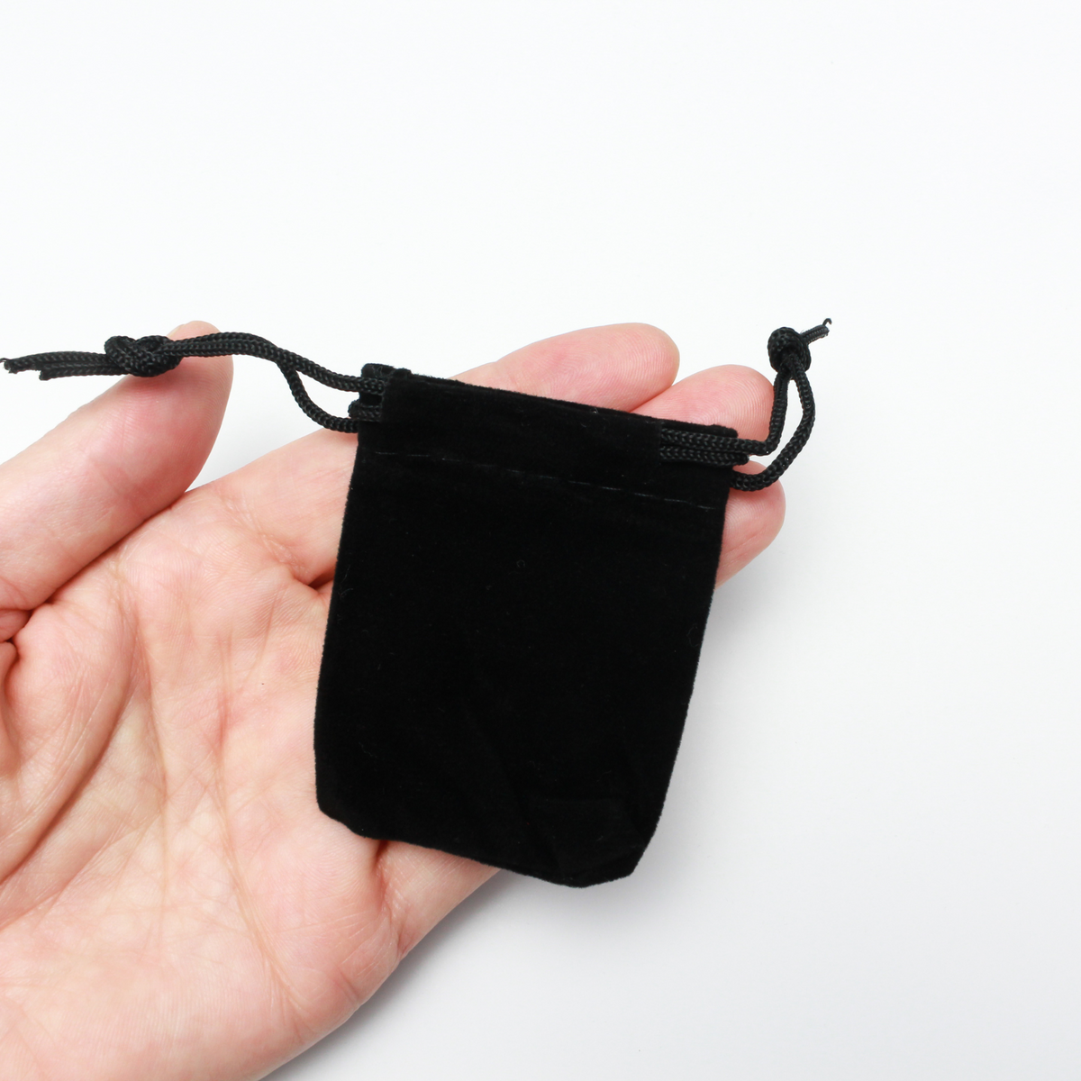 Small black velvet drawstring pouch that is 2.5" x 2"