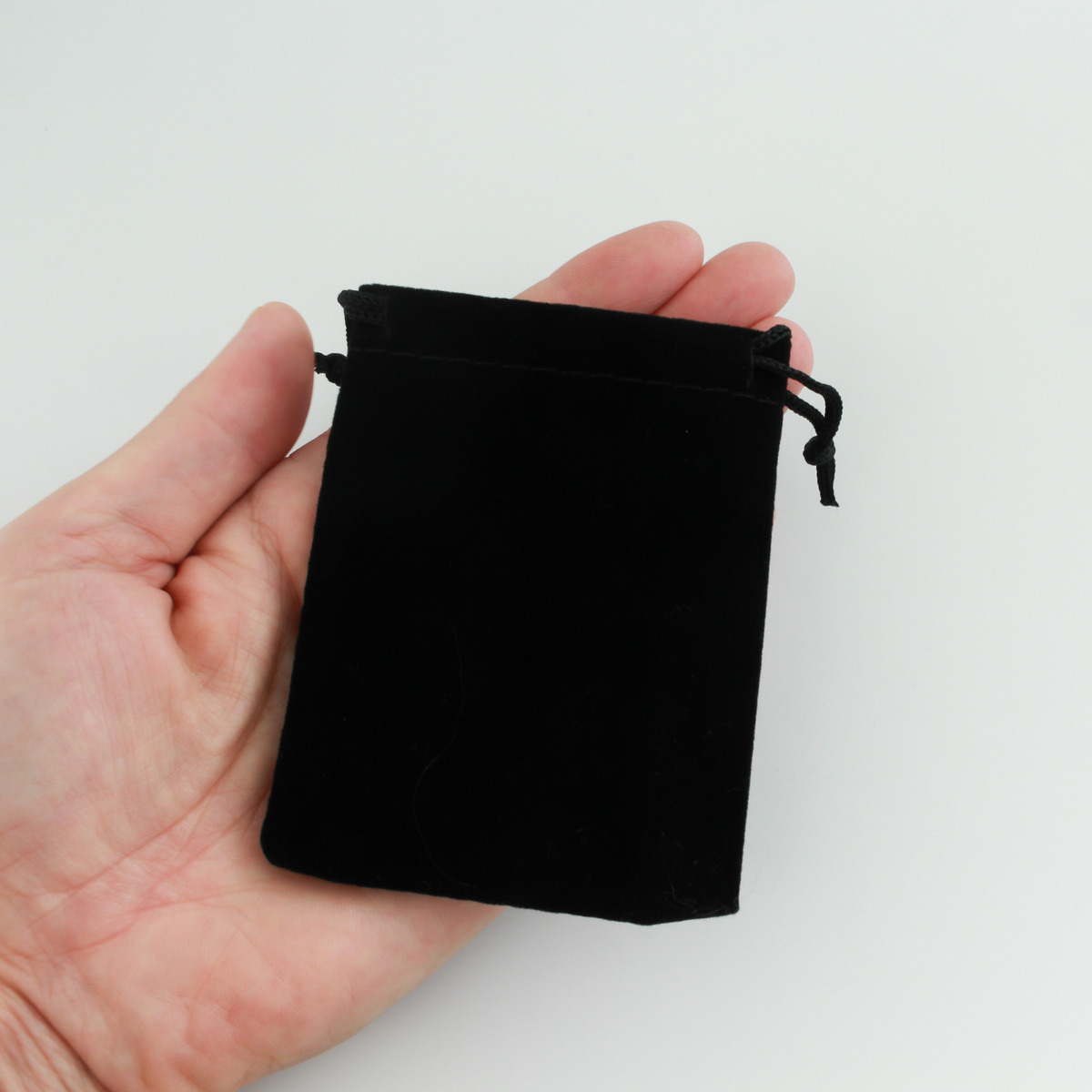 Small black velvet drawstring pouch that is 3.5" x 2.875"
