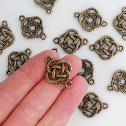 Bronze Celtic knot connectors with a filigree cut out design