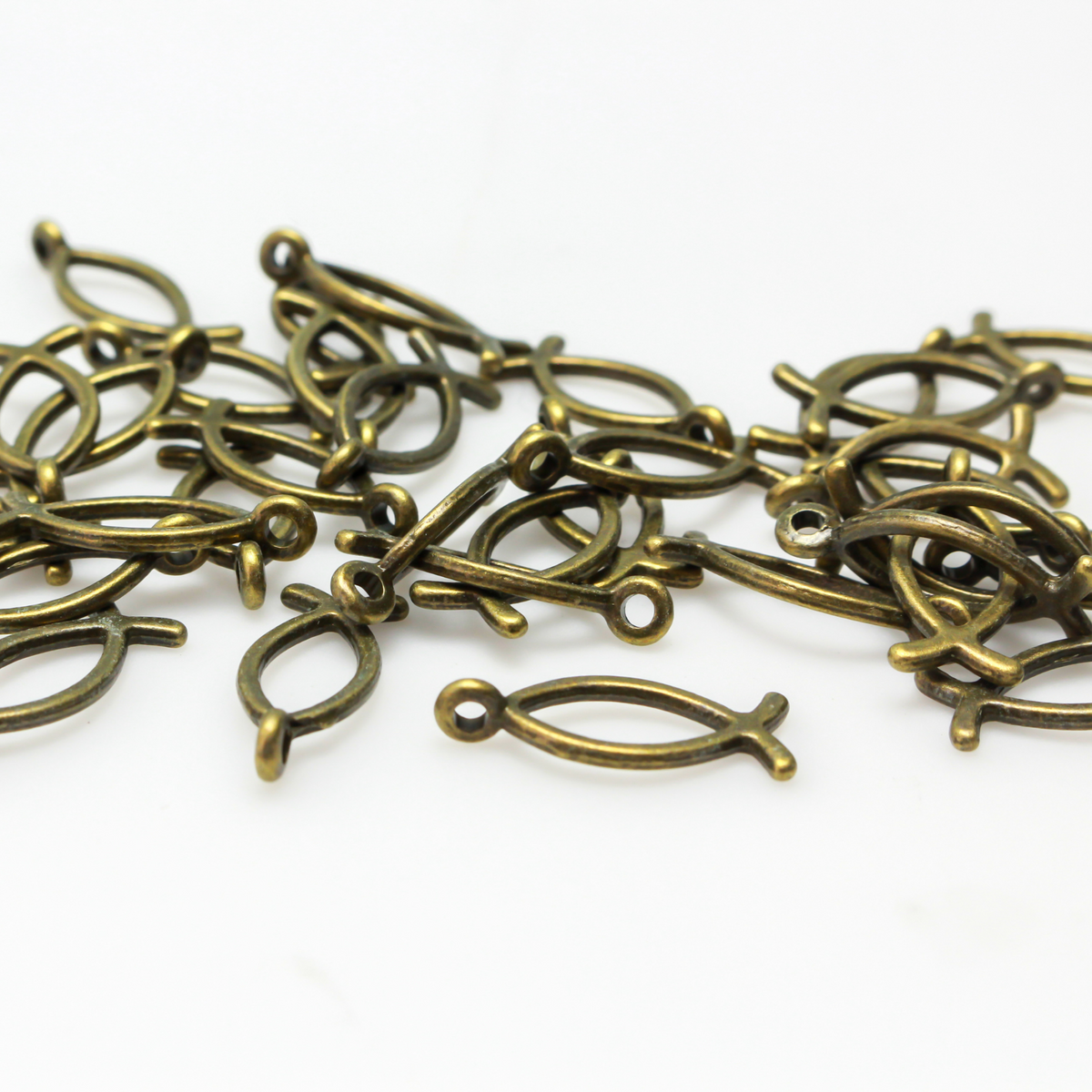 Bronze-tone fish-shaped charm also known as the Ichthys symbol for Jesus