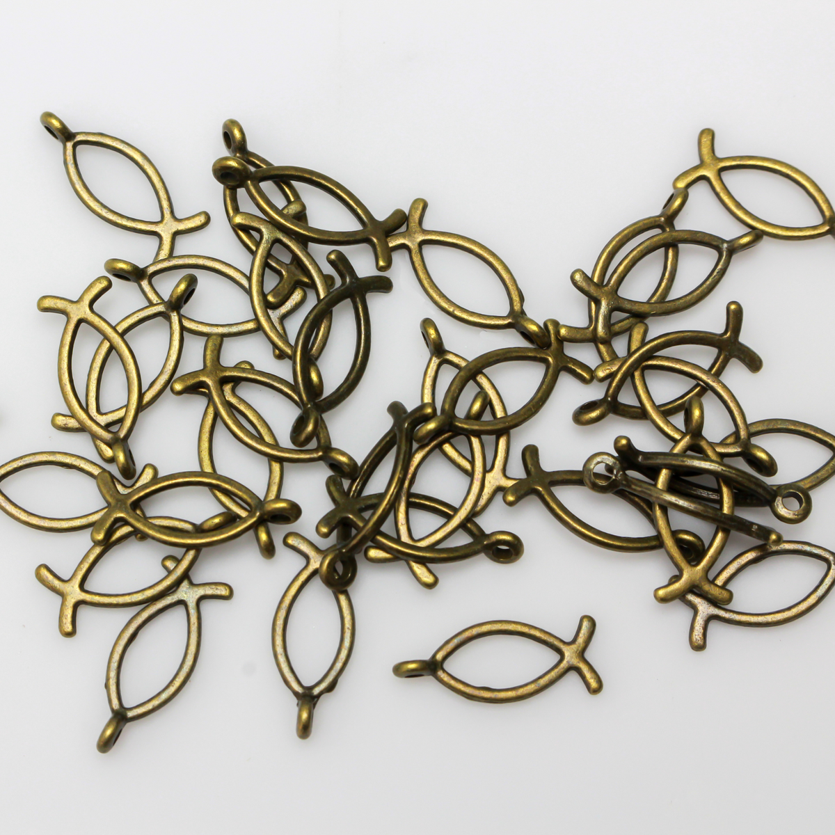 Bronze-tone fish-shaped charm also known as the Ichthys symbol for Jesus