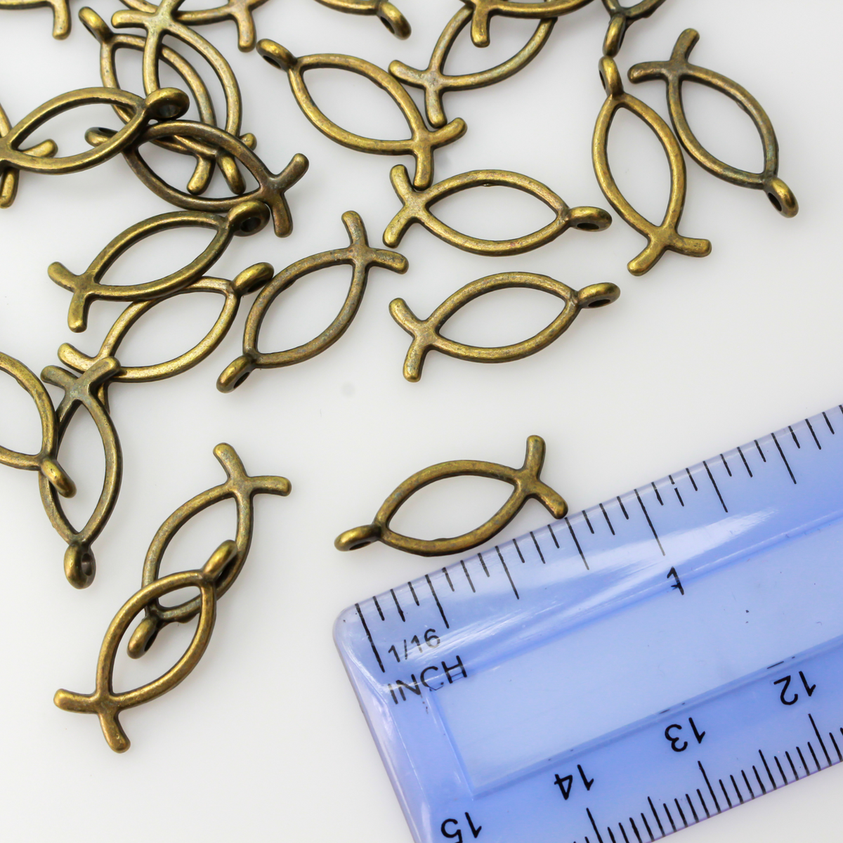 Bronze-tone fish-shaped charm also known as the Ichthys symbol for Jesus