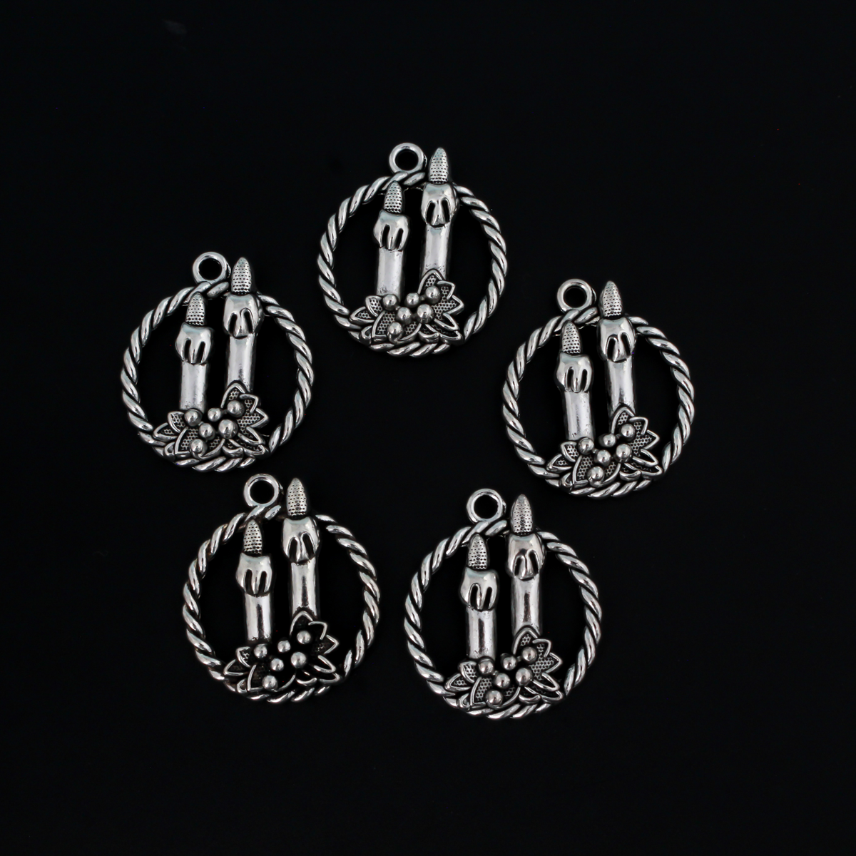 Silver tone charms of a Christmas wreath with two candles, 30mm long
