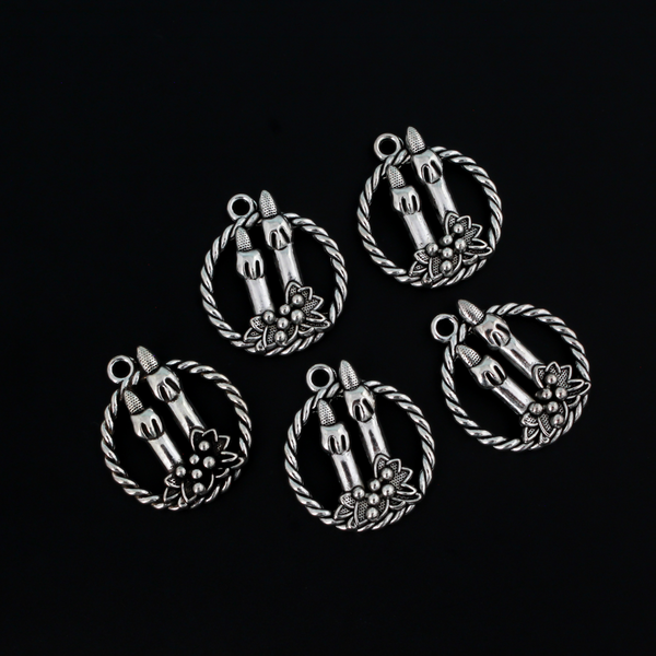 Silver tone charms of a Christmas wreath with two candles, 30mm long