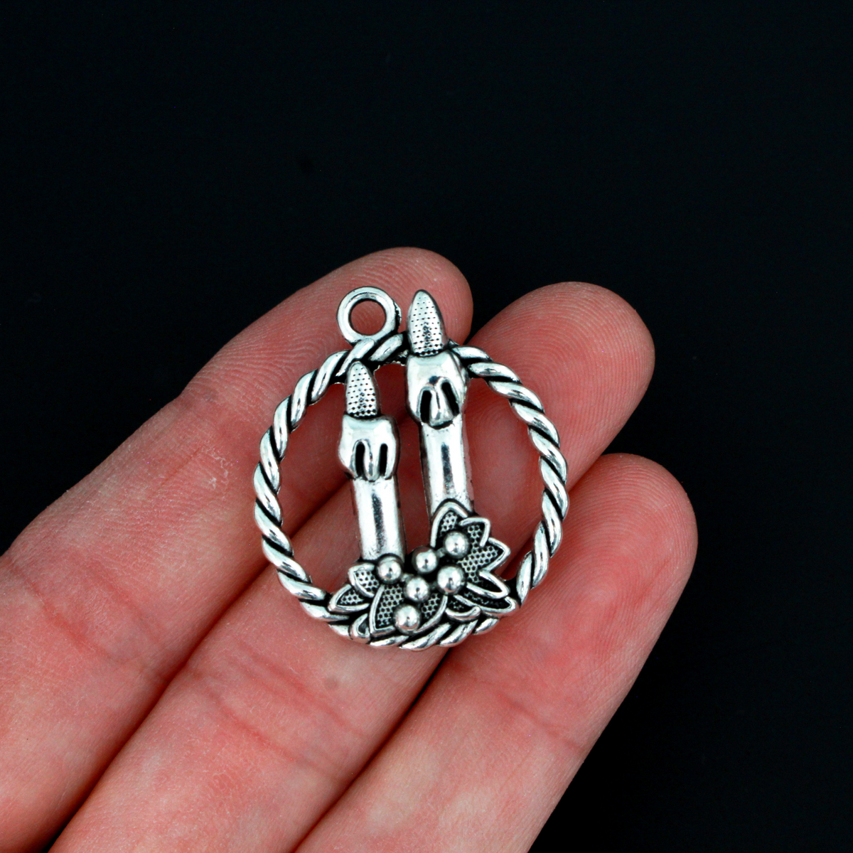 Silver tone charms of a Christmas wreath with two candles, 30mm long