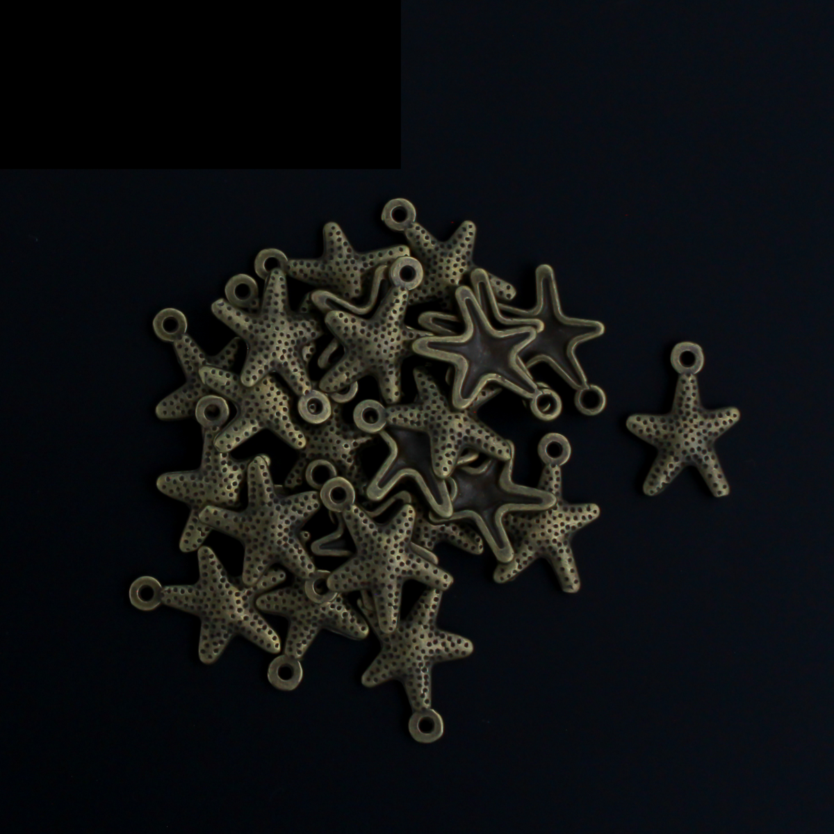 16mm long starfish charms in an antiqued bronze color.