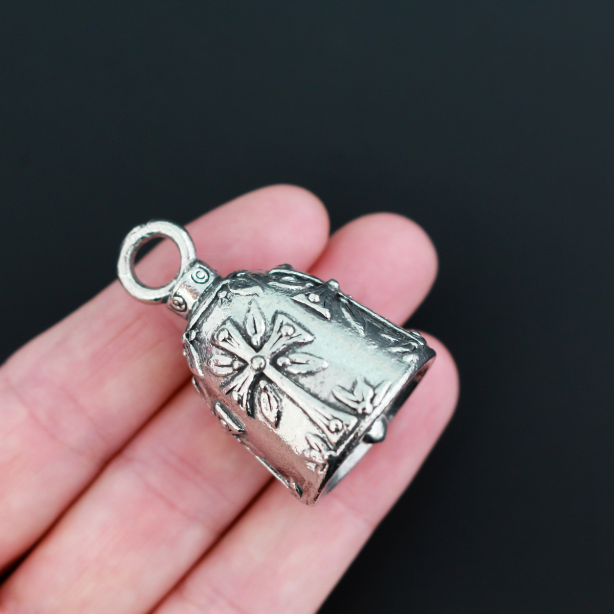 Christian Cross Guardian bell. There are four cross symbols encircling the bell.