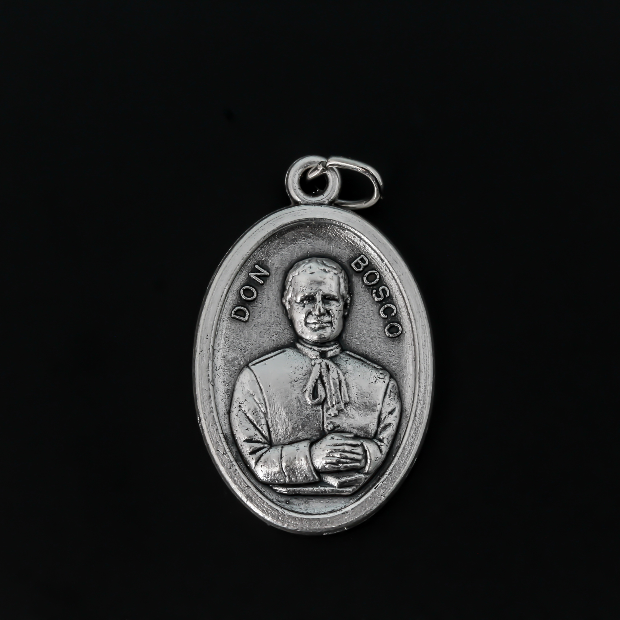 Saint Giovanni "Don" Bosco oval medal that depicts St. Don Bosco on the front and Mary, Help of Christians, on the bac