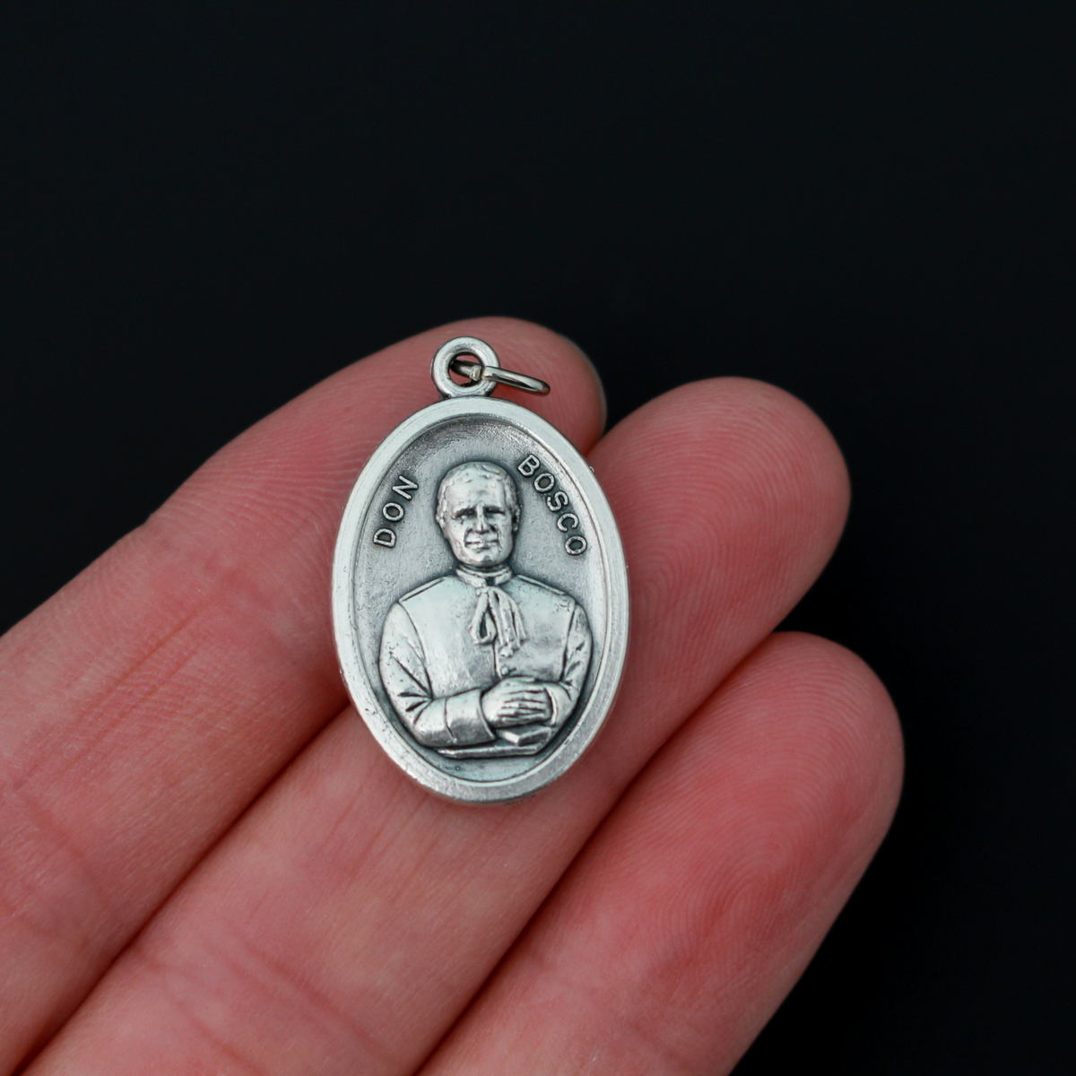 Saint Giovanni "Don" Bosco oval medal that depicts St. Don Bosco on the front and Mary, Help of Christians, on the bac