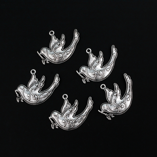 silver tone dove charm carrying an olive branch which is a symbol of peace, 28mm x 22mm