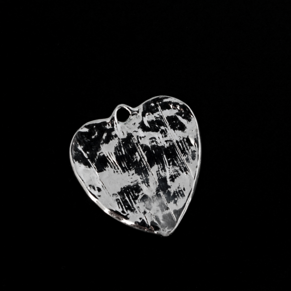 Shiny silver heart charms engraved with a bible passage from First Corinthians 13:13 “And now these three remain: faith, hope and love. But the greatest of these is love." The backside of the charm is blank with a pattern.