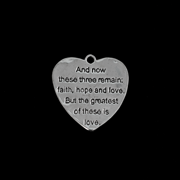 Shiny silver heart charms engraved with a bible passage from First Corinthians 13:13 “And now these three remain: faith, hope and love. But the greatest of these is love." The backside of the charm is blank with a pattern.
