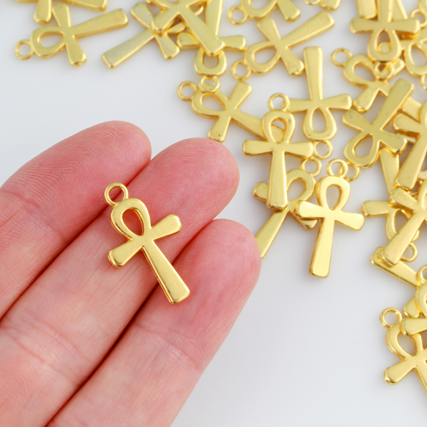 Egyptian Ankh cross charms that are a zinc alloy base with a shiny gold plating.