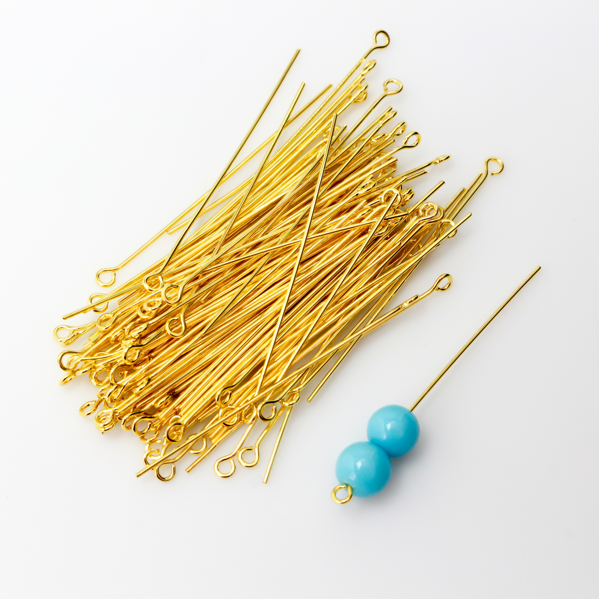 Brass eye pins with a shiny gold plating. They are 50mm long and 0.7mm thick (21 gauge)