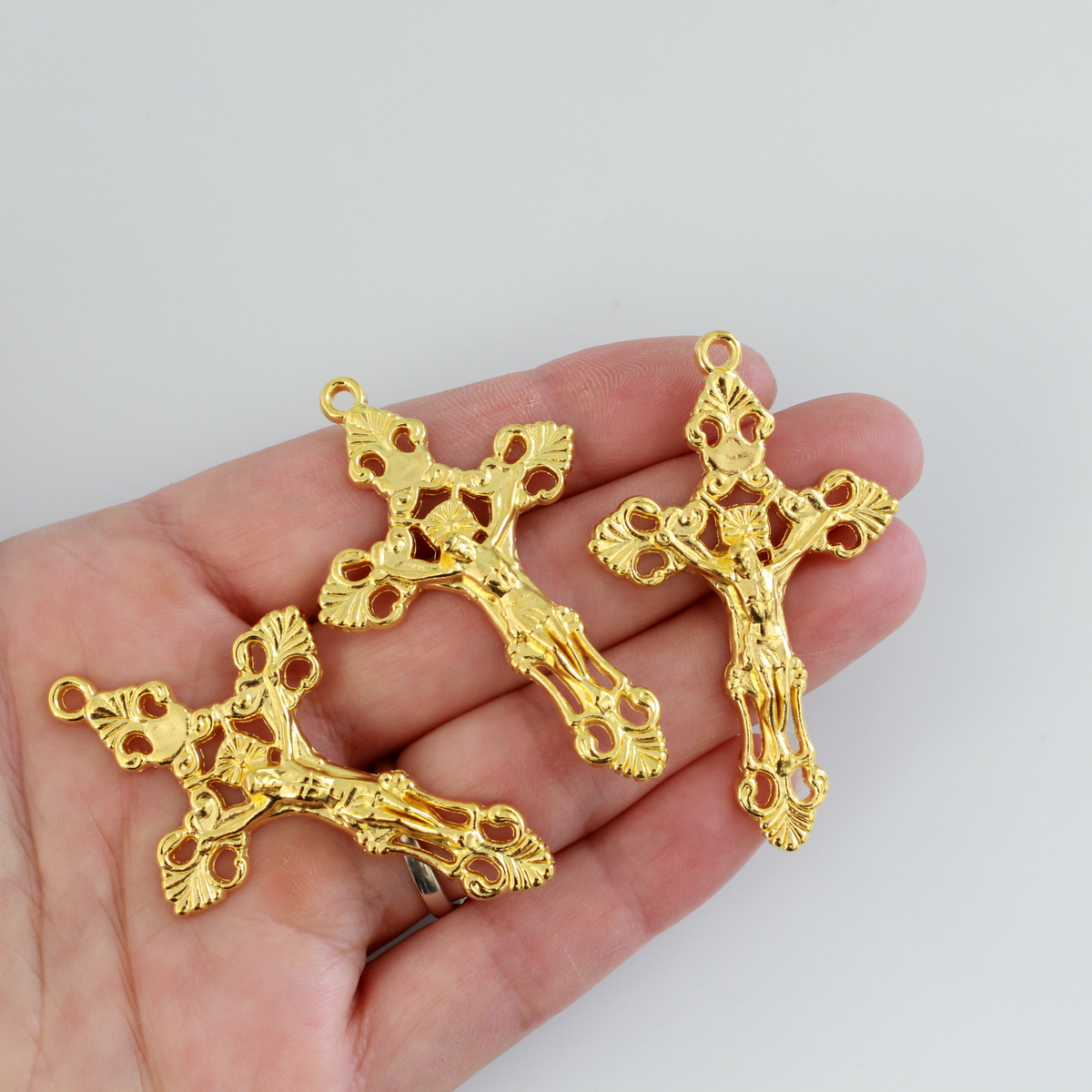 Three ornate fleur de lis crucifix cross in a shiny gold color and filigree cut out design, 2-1/8" long