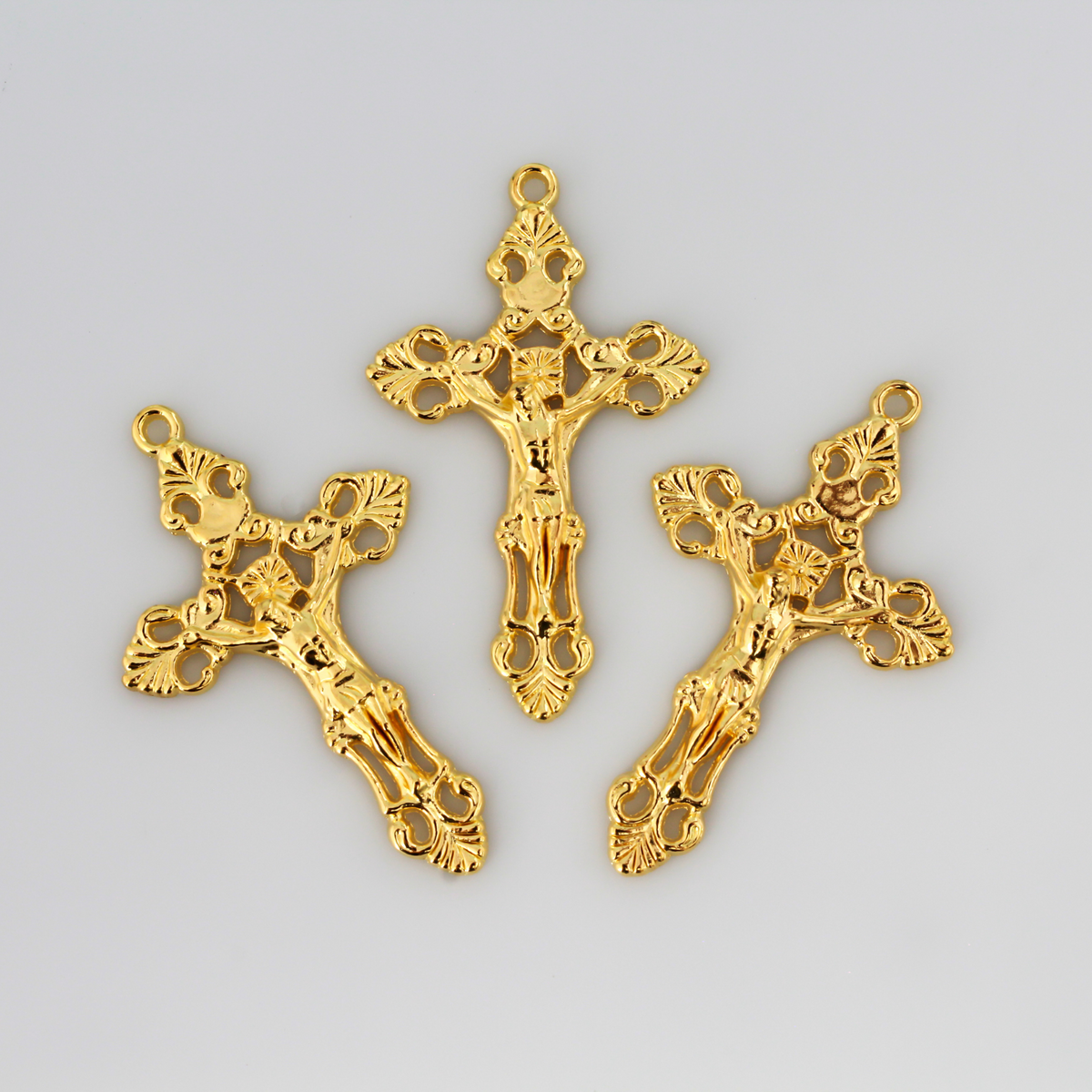 Three ornate fleur de lis crucifix cross in a shiny gold color and filigree cut out design, 2-1/8" long