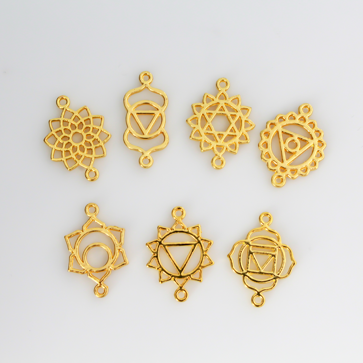 Set of seven chakra symbols of the human body. These are connector links with a bail on each end to use as bracelet connectors, etc