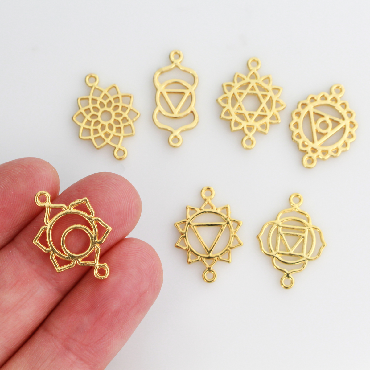 Set of seven chakra symbols of the human body. These are connector links with a bail on each end to use as bracelet connectors, etc