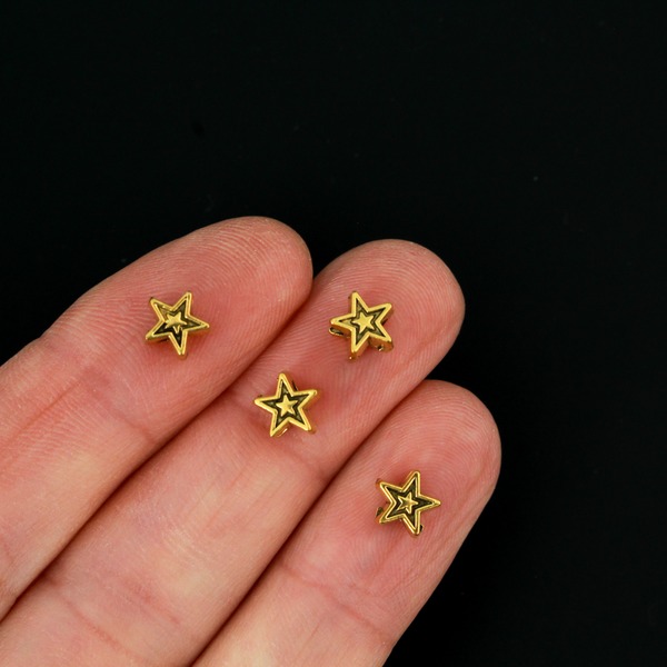 Tiny gold-tone metal beads shaped like five pointed stars, perfect for rosaries, chaplets, bracelets
