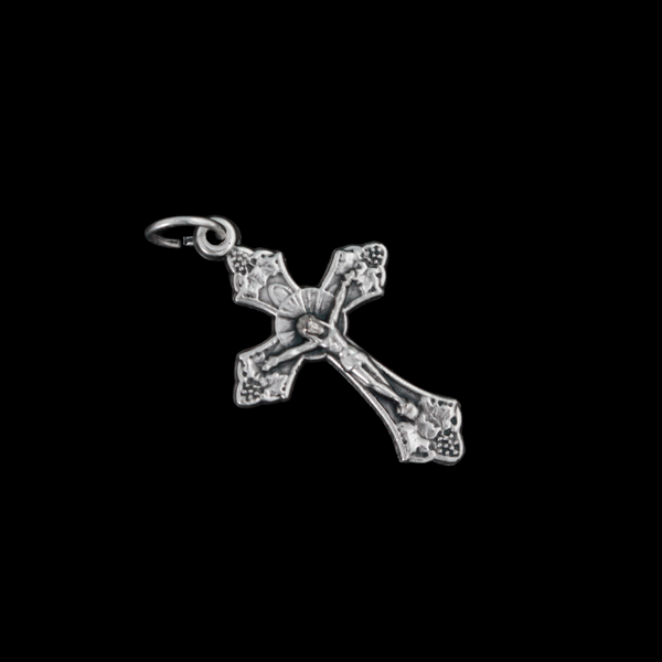 Small silver tone crucifix that features beautiful grape and leaf accents around the figure of Christ on the cross