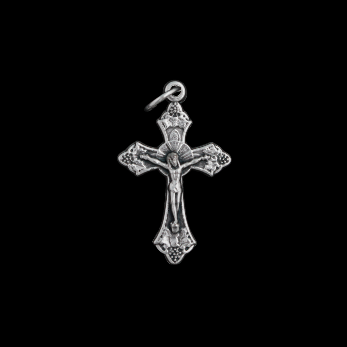 Small silver tone crucifix that features beautiful grape and leaf accents around the figure of Christ on the cross