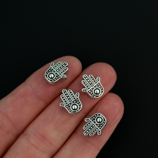 antiqued silver tone hamsa hand beads that are 12mm long by 10mm wide with 1.5mm hole