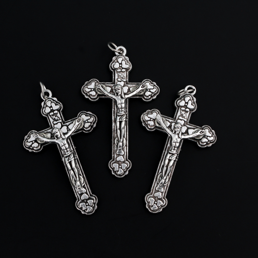 Detailed crucifix that is Byzantine in style with a heart design on the crossbeams behind the body of Jesus.