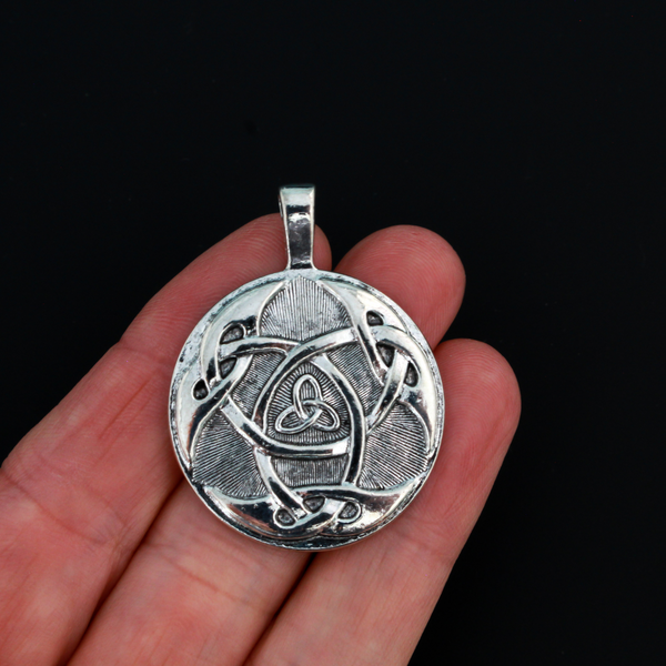 Large Celtic trinity knot pendant that is antiqued silver tone in color with a large attached bail