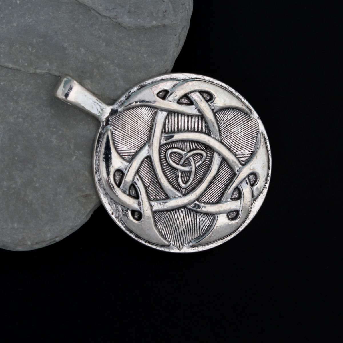 Large Celtic trinity knot pendant that is antiqued silver tone in color with a large attached bail