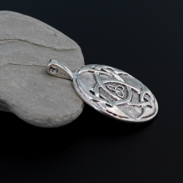 Large Celtic trinity knot pendant that is antiqued silver tone in color with a large attached bail