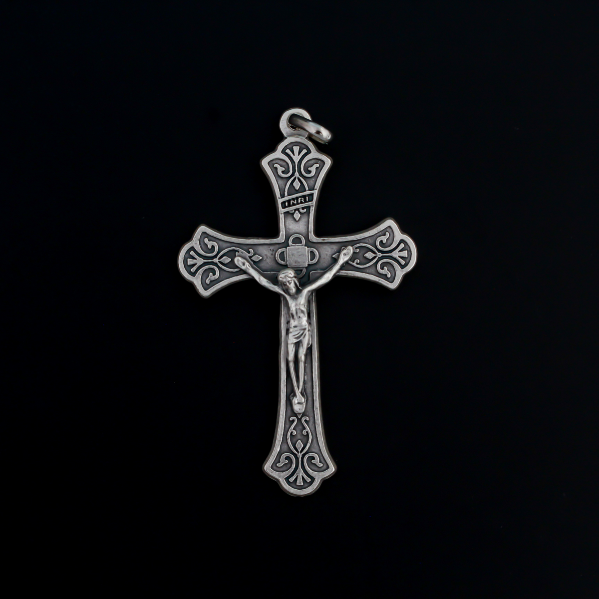 Large ornate crucifix with flared edges. Beautiful raised relief scroll work pattern on the bars of the cross.