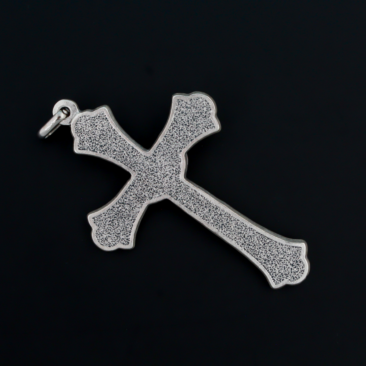 Large ornate crucifix with flared edges. Beautiful raised relief scroll work pattern on the bars of the cross.