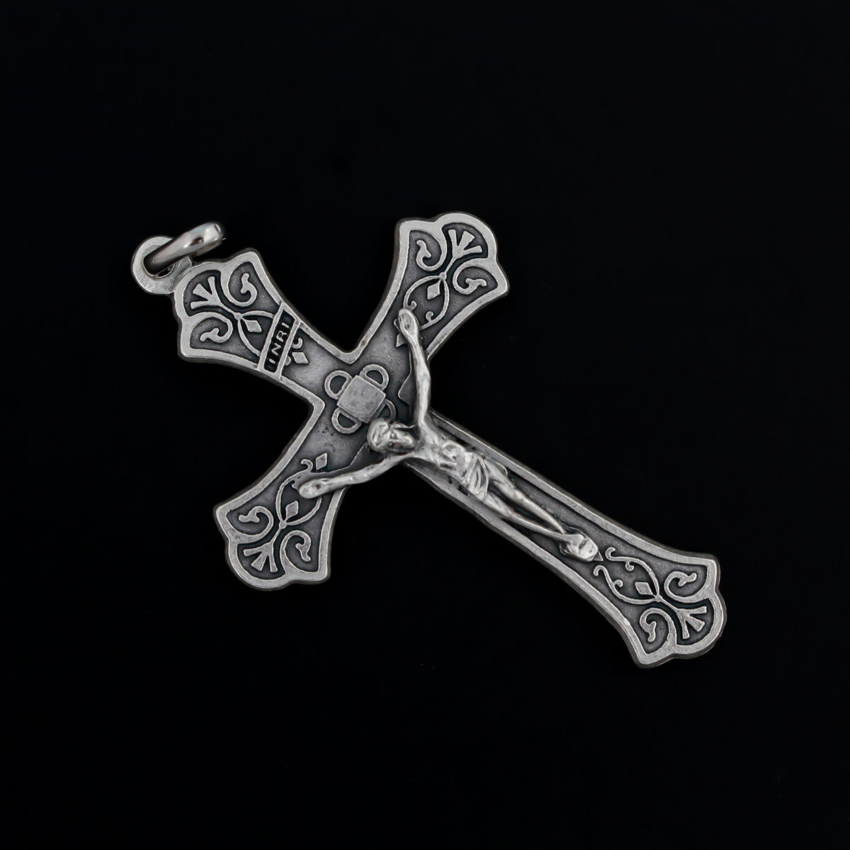 Large ornate crucifix with flared edges. Beautiful raised relief scroll work pattern on the bars of the cross.