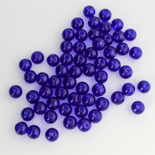 8mm round glass beads in a dark midnight blue color that is transparent.