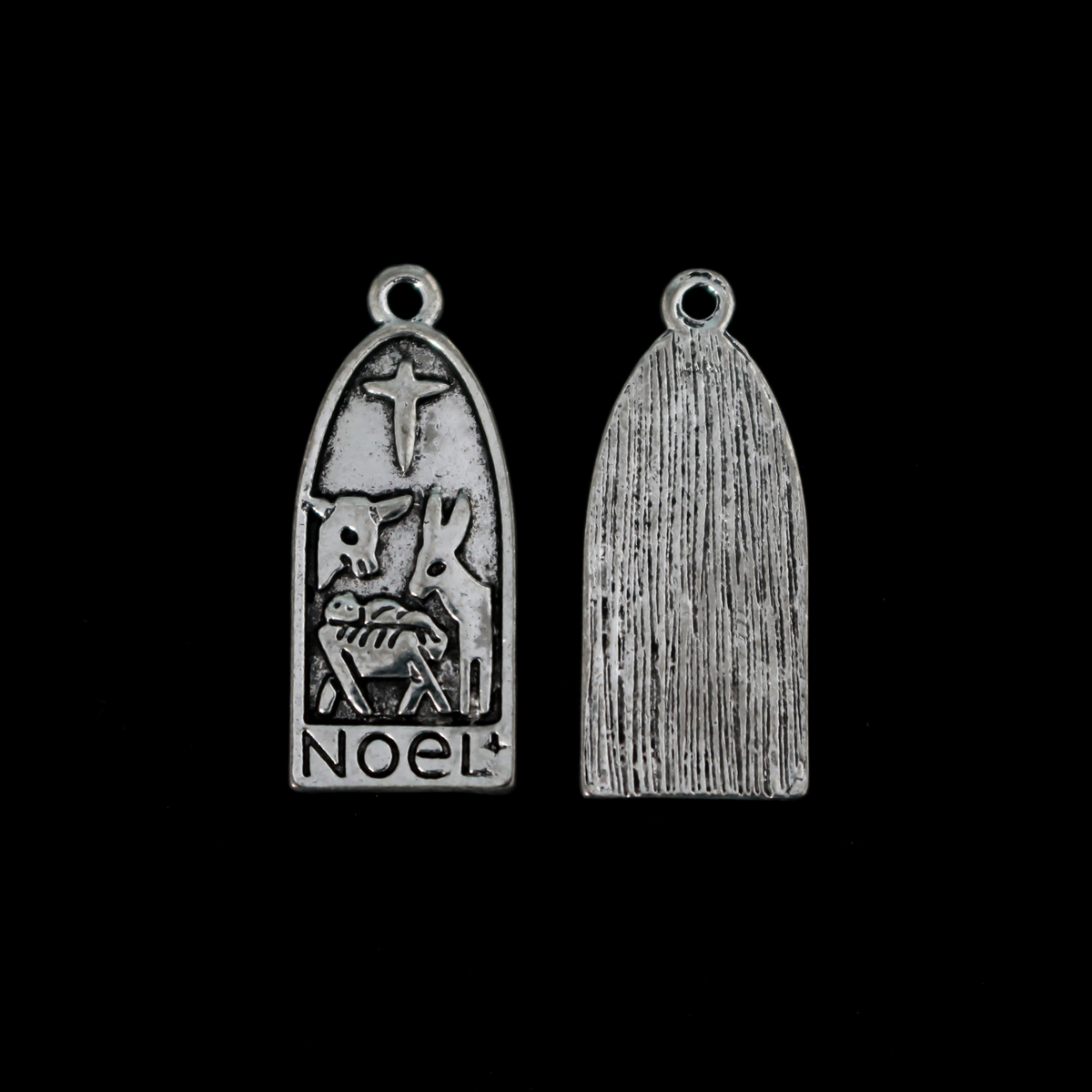 Arched charm depicting Christ child in the manger with the Christmas Star or the Star of Bethlehem above and a donkey and cow on either side