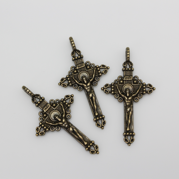 Three ornate crucifix crosses in an antiqued bronze color, 2 inches long