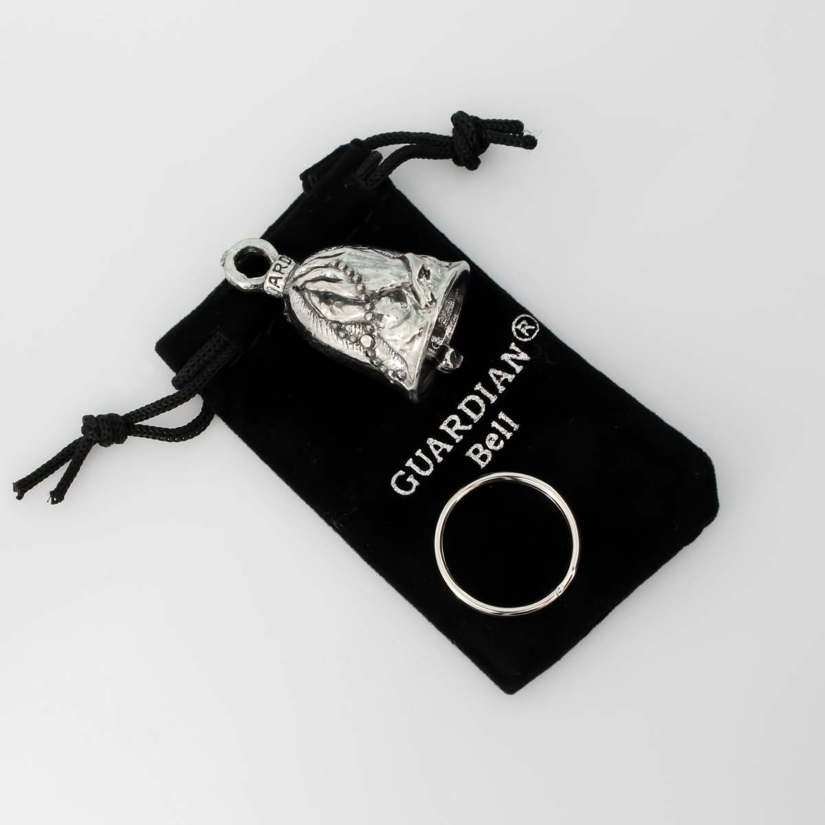 Praying hands Guardian bell. The front of the bell depicts a pair of hands in prayer holding a rosary. The rosary is also on the backside of the bell.
