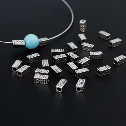 Rectangle shaped spacer beads that have a dimple dot pattern on all four sides 6mm x 3mm