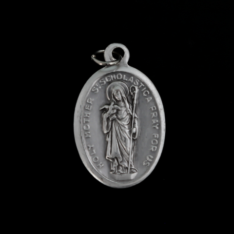 Holy Mother Saint Scholastica medal that depicts the saint on the front and is marked "Pray For Us" on the back
