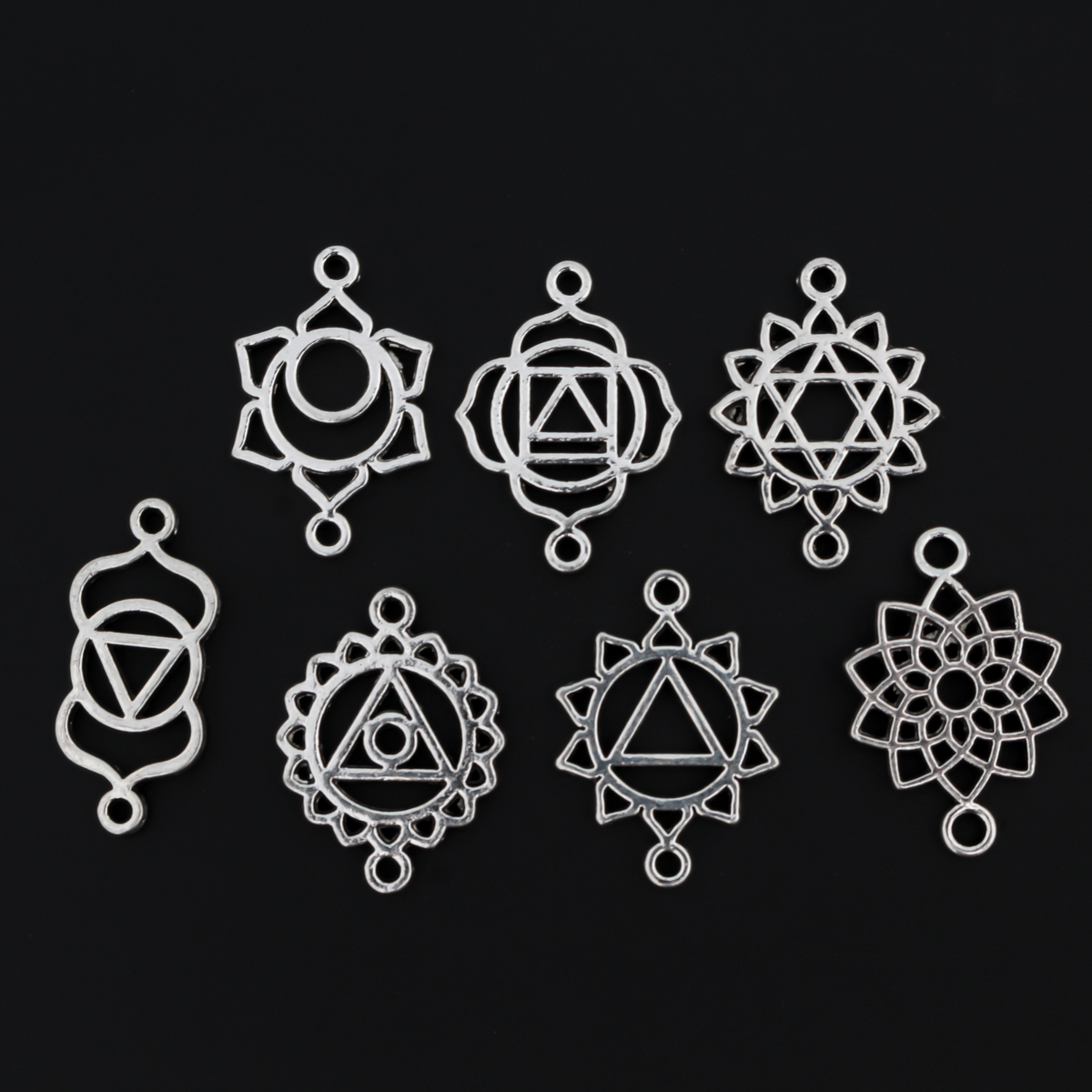 Set of seven chakra symbols of the human body. These are connector links with a bail on each end to use as bracelet connectors, etc
