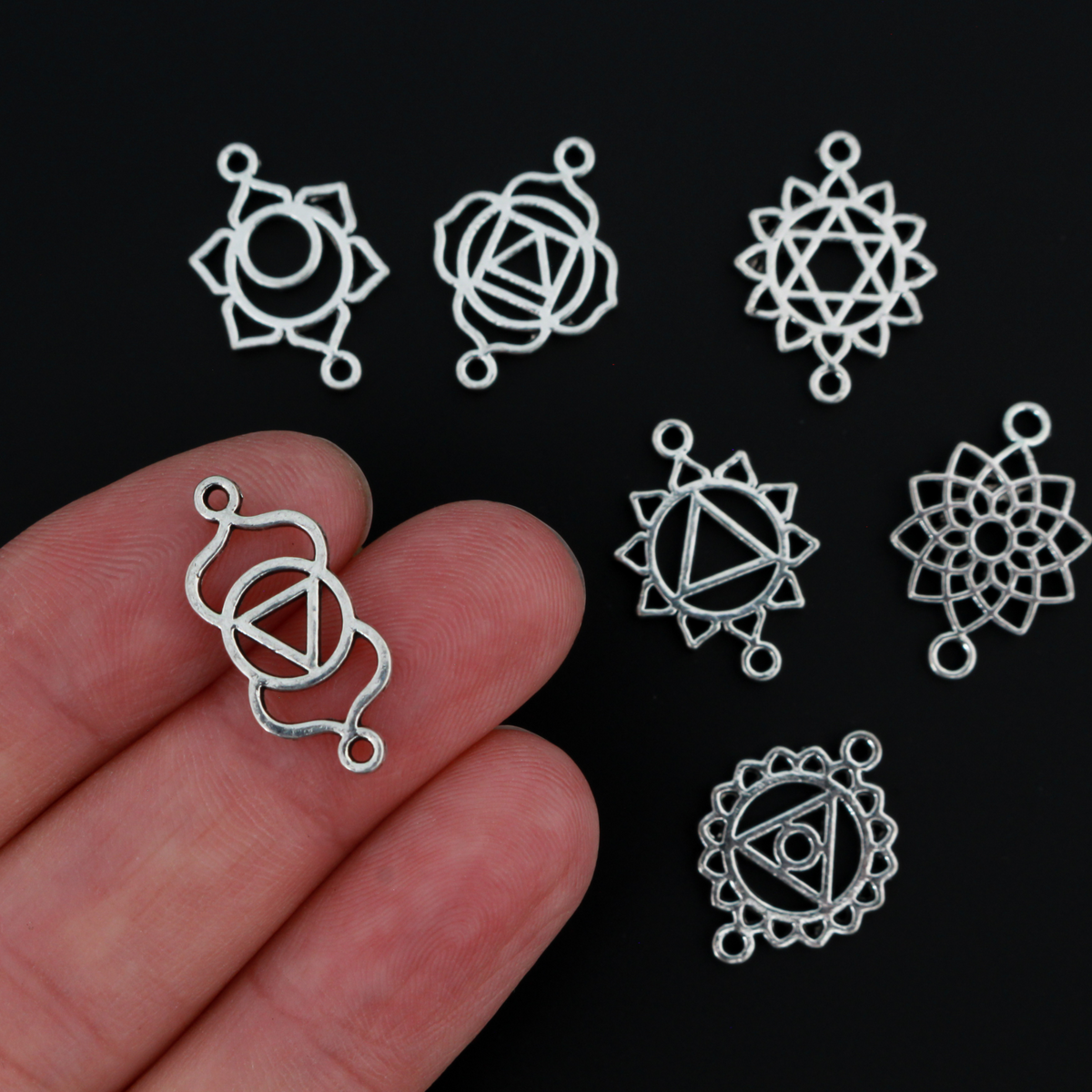 Set of seven chakra symbols of the human body. These are connector links with a bail on each end to use as bracelet connectors, etc