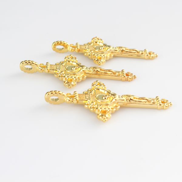 Three ornate crucifix crosses in a shiny gold color. This is a larger size crucifix measuring 2" long.