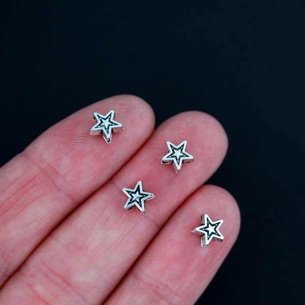 Tiny silver-tone metal beads shaped like five pointed stars, 6mmx6mm