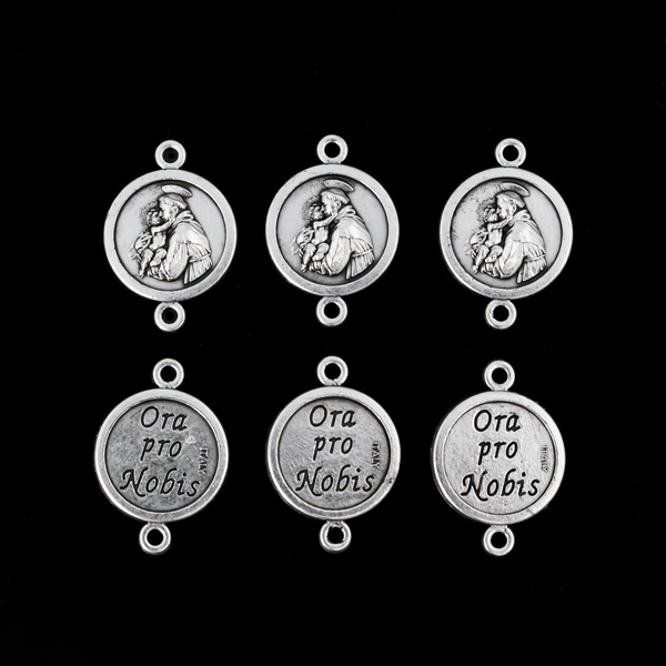 Saint Anthony round flat connector links that are silver oxidized plating on a base metal. The backside is marked "Ora Pro Nobis" in Latin which translates to pray for us.